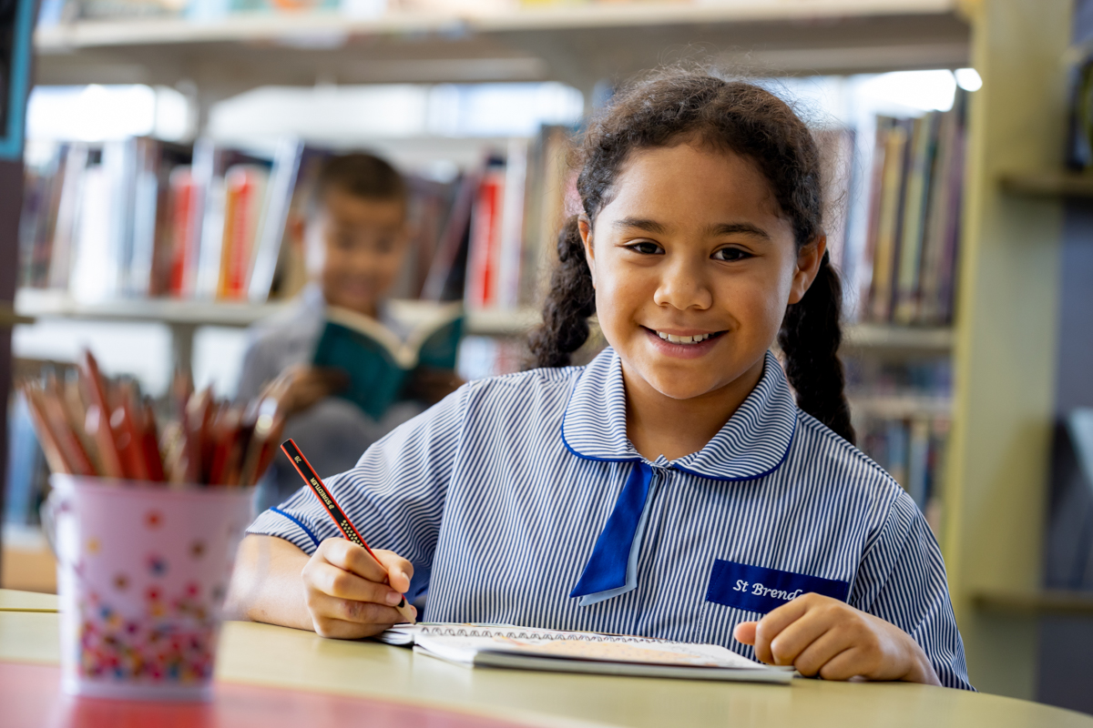 Student writing in notebook